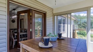 A wooden dining table with a blue mug, a blue bowl, and a potted plant. - Pigeon Forge Getaway, Hot Tub, Game Room, Wifi, $560 FREE tickets each paid day! (Pigeon Forge)