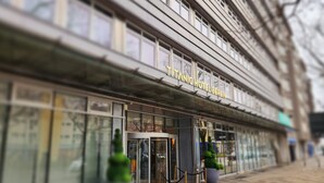 The exterior of the Titanic Hotel building with a revolving door entrance and a sign above the door. - TITANIC Comfort Kurfürstendamm (Berlin)