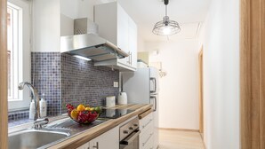 A modern kitchen with a stainless steel sink, a microwave, and a built-in oven. - Armonia GuestHouses by Konnect, Benitses (Corfu)