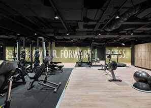 A gym with exercise equipment, a mirrored wall, and a motivational phrase. - Travelodge Hotel Hurstville Sydney (Hurstville)