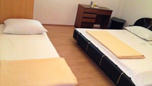 Une chambre double avec deux lits, un bureau et une chaise.
