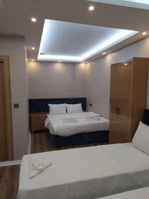 Ein modernes Schlafzimmer mit Dachfenster, einem Bett, einem Kleiderschrank und einem Nachttisch.