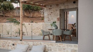 A stone patio with outdoor seating, a pergola, and a view of a stone wall and trees. - Sea View Villa w/Private Pool, 400m to the beach (Heraklion, Crete)