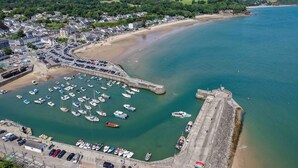 A coastal town with a marina, sandy beach, and residential area.