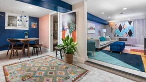 A modern living room with a sofa, a coffee table, and a rug. - Artistic Craftsman Style Home Downstairs Apartment (Portland)