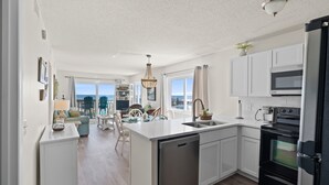 A modern kitchen with a dishwasher, oven, and microwave.