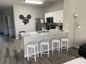 Fridge, stovetop, dishwasher, coffee/tea maker