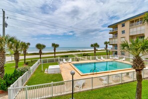 Enjoy ocean views from the pool area, complete with lounge chairs and sunbeds.