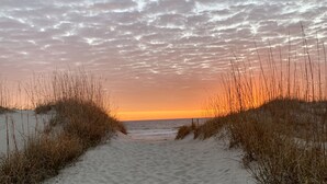 A sandy beach path leading to the ocean with sparse vegetation on either side. - Charming Studio / Cottage in Marina BHI & Shoals Club Available (Bald Head Island)