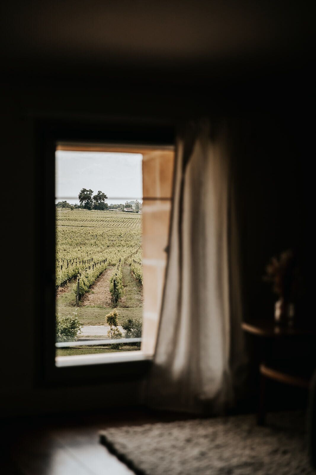 Ein Zimmer mit Fensterblick auf einen Weinberg.