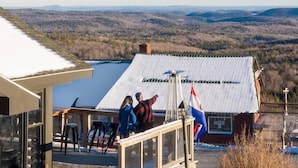 A building with a sloped roof overlooking a valley.