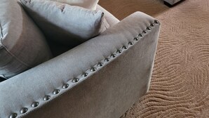 A grey sectional sofa with a small side table, a matching ottoman, and decorative pillows. - NFL Draft: Close to Lambeau and Appleton & Oshkosh airports. Sleeps  8+ (Appleton)