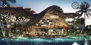 A resort with a pool, outdoor seating, and a thatched-roof bar area. - Upscale resort with 3 restaurants, 2 I formal bars and Infinite pool  (San Jose Del Cabo)