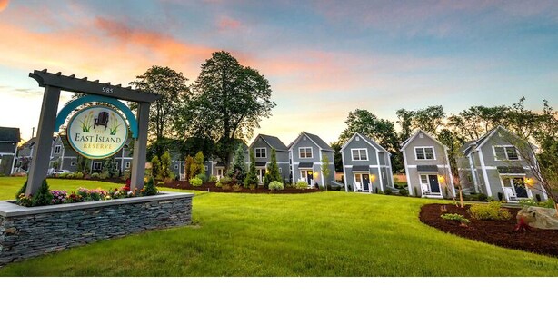 A row of houses with a stone wall and a sign for East Island Reserve. - Cottages with easy access to Newport, beaches, nature trails  and  vineyards (Middletown)