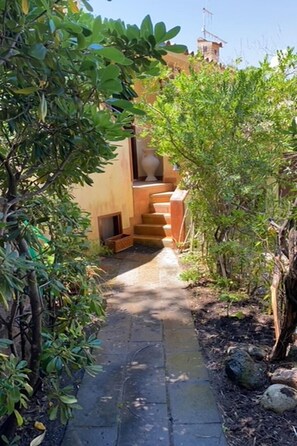 Stroll through lush gardens to a unique, multi-level building with a blend of traditional and modern design.
