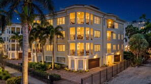 A multi-story hotel with balconies, a parking area, and a night sky. - At Sun Sea Terrace | Luxury Siesta Key Condo w/ Heated Pool, Short Walk to Beach and Village (Siesta Key)