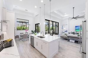 Enjoy meal preparation in this kitchen with a central island, dishwasher, and large sink.
