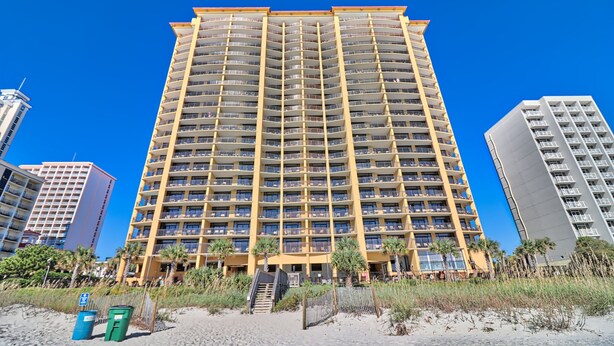 A multi-story hotel with balconies, located near a beach. - 5-Star Luxury, Fully Updated OCEANFRONT 2 Bed/ 2 Bath FALL STAYS 50% OFF RESORT! (Myrtle Beach)