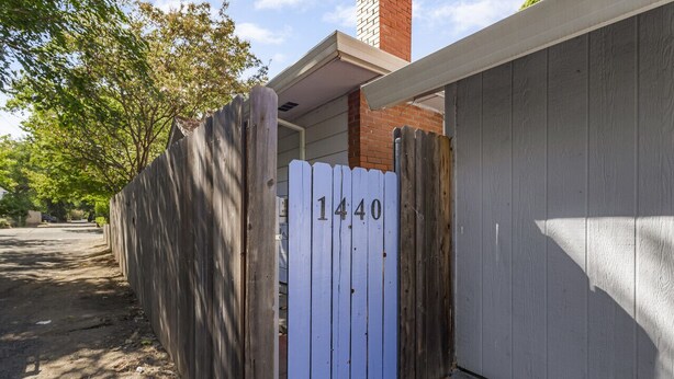 A residential property with a wooden fence and a garage door. - Charming Avenue Guest House (Chico)