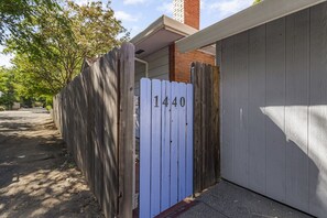 A residential property with a wooden fence and a garage door. - Charming Avenue Guest House (Chico)