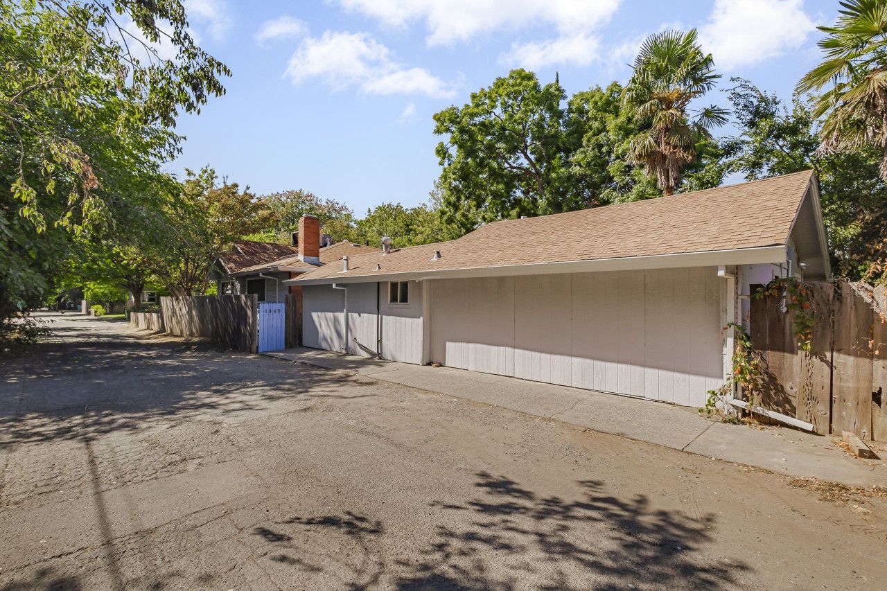 A single-story house with a garage, a driveway, and a wooden fence.