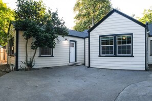 A two-story house with a front entrance, a side door, and a garage. - Lovely House near Downtown, Your Home away from Home! (Chico)