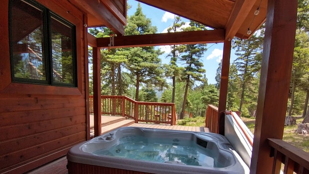 A wooden hot tub on a deck with a view of a forest. - Mountain Cabin with Multi-level Decks, Views, Hot Tub, Family Memories Made Here (Angel Fire)