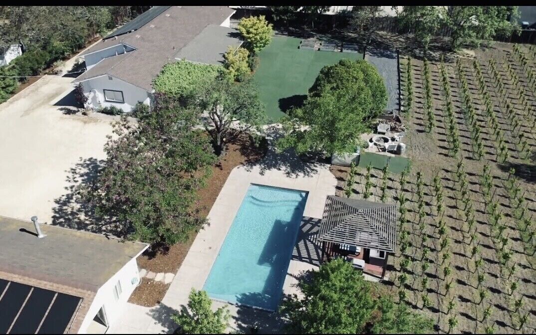A gated vineyard oasis with main house, pool house, hot tub, bocce & more