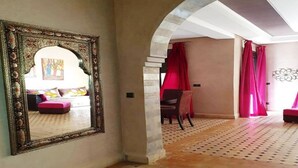 A room with a patterned floor, a large ornate mirror, and red curtains. - Pleasant apartment in Premium Village Marrakech 5239 (Marrakech)