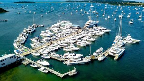 An aerial view of a marina with numerous boats docked in a circular pattern. - Champlin's Marina & Resort (Block Island)