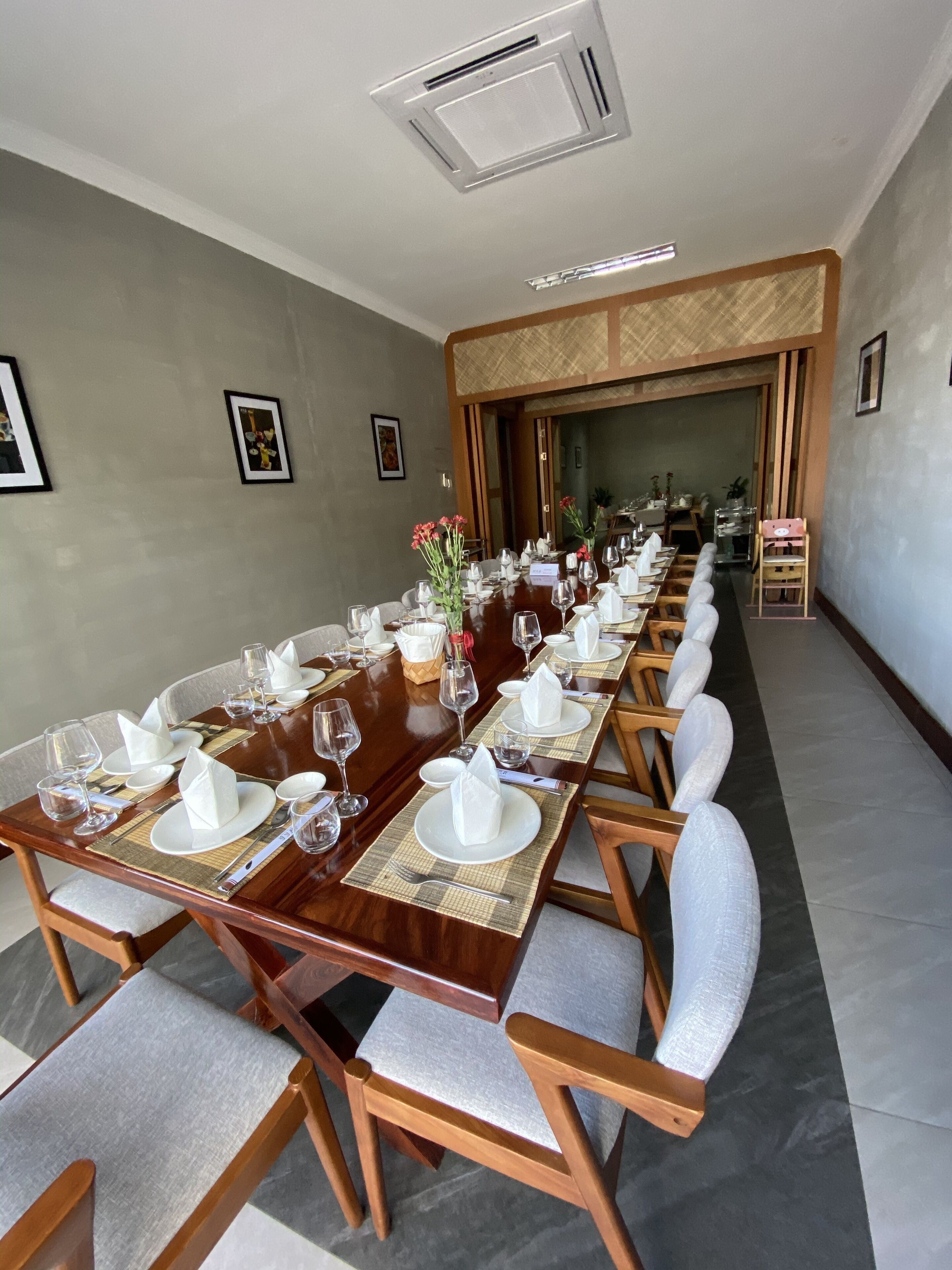 A long dining table set for a formal meal, with chairs and place settings.