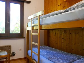 A bunk bed with a ladder, a window, and a chair. - Chalet Al Portic by Interhome (Olivone)