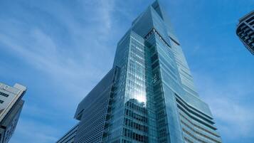 A high-rise building with a modern glass facade and a distinctive angular design.