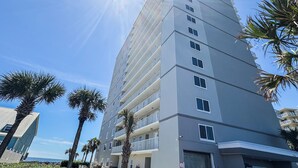 A tall, multi-story hotel with balconies and a clear view of the ocean. - Beautiful Ocean Views 2/2 Condo  (Orange Beach)