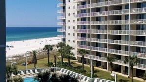 A multi-story hotel with balconies, a pool, and a beach view. - Beautiful Ocean Views 2/2 Condo  (Orange Beach)