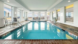 An indoor swimming pool with clear markings, a wooden deck, and a view of the outside. - Fairfield Inn & Suites by Marriott Louisville Shepherdsville (Louisville)