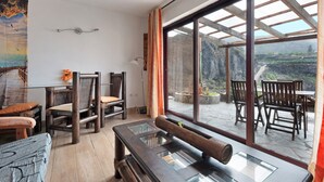 A room with a large window, wooden furniture, and a view of a mountainous landscape. - Apartament Ana with Mountain View, Sea View, Wi-Fi & Terrace (San Marcos)