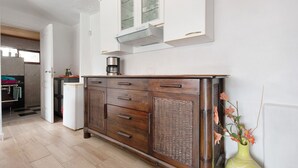 A kitchen with a built-in microwave, a coffee maker, and a cabinet with glass doors. - Apartament Ana with Mountain View, Sea View, Wi-Fi & Terrace (San Marcos)