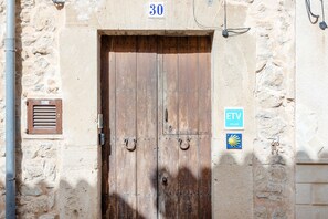 A wooden door with a metal handle, a number '30' above it, and a sign with 'ETV' and a sun symbol. - Holiday Home Casa Maria Angela with Sun Terrace, Patio and Wi-Fi (Arta)