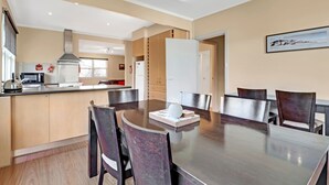 A modern kitchen with a dining area.
