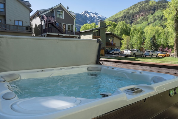 Relax in a serene hot tub on a deck with breathtaking views of the surrounding landscape.