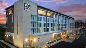 A modern hotel with a prominent 'AC Hotels Marriott' sign, multiple floors, and a covered entrance area. - AC Hotel by Marriott Jackson Ridgeland (Ridgeland)