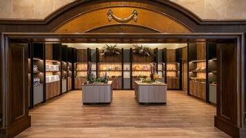 Enter a grand lobby with a classic design, featuring an arched entrance and two modern reception desks.
