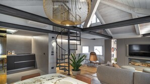 A modern interior with a marble dining table, a staircase, a sofa, and a TV. - San Marco View Terrace Apartment R&R (Venecia)
