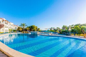 Seasonal outdoor pool, open 3:00 PM to 7:00 PM, pool umbrellas