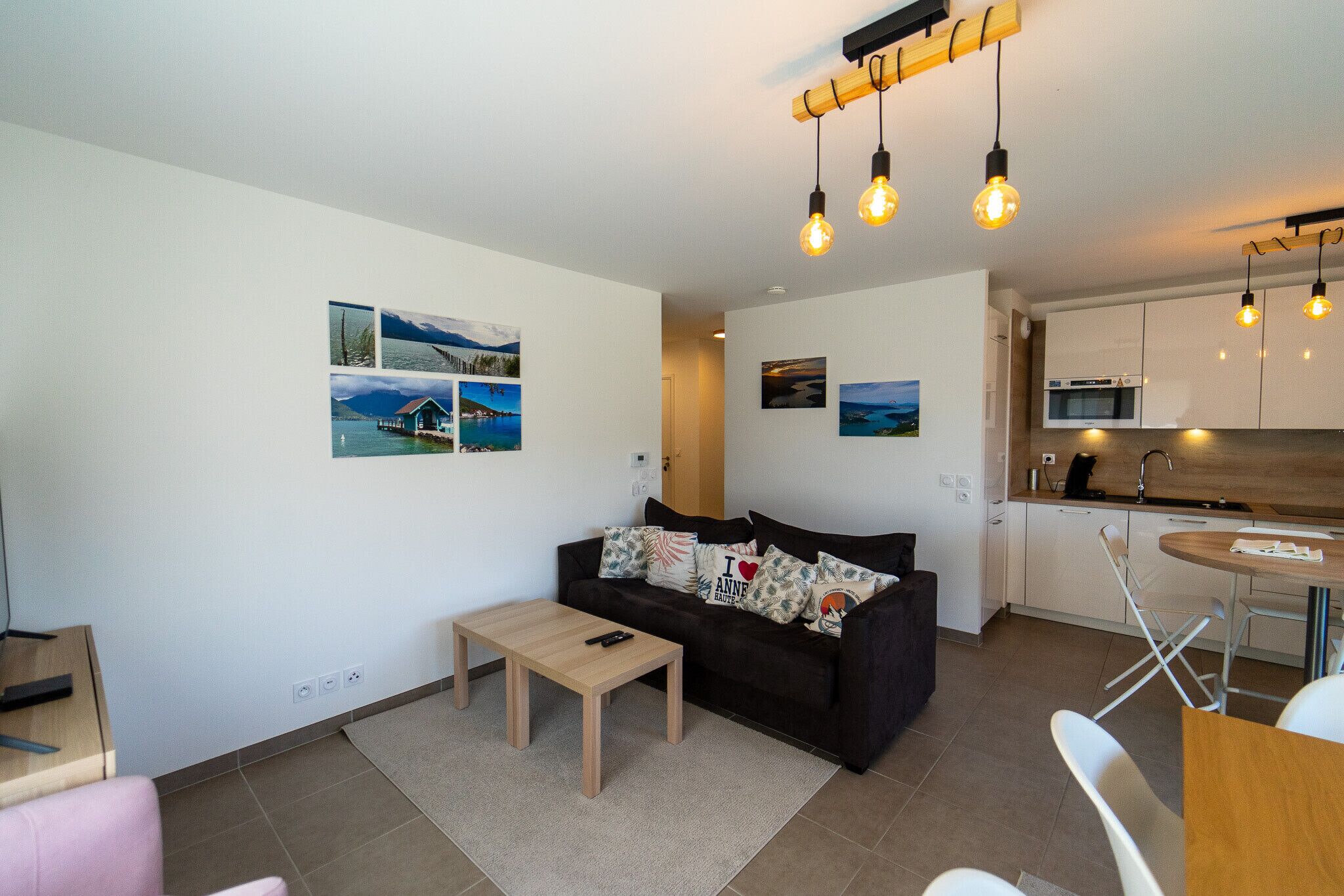 A modern living room with a sofa, coffee table, and artwork on the wall.
