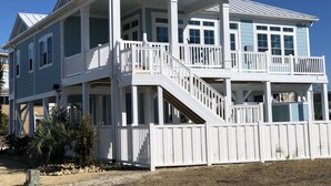 A two-story beachfront house with a balcony, a staircase, and a covered porch. - Custom 3BR 3BA with Private Pool & Elevator - new in 2022 (Sunset Beach)