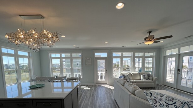 A spacious kitchen with a central island, large windows, and a ceiling fan. - Custom 3BR 3BA with Private Pool & Elevator - new in 2022 (Sunset Beach)