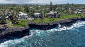 A coastal property with houses on a rocky cliff overlooking the ocean. - Paradise Ocean View, 2Br/2Ba (Keaau)