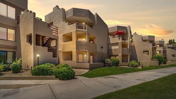 A modern multi-story building with balconies and a central staircase. - Villa Stone Creek 2 Bedroom Condo by RedAwning (Scottsdale)